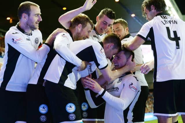 St Johnstone players congratulate goalscorer Michael O'Halloran (bottom) after scoring his side's third at Ibrox. Picture: SNS