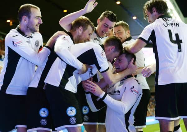 St Johnstone players congratulate goalscorer Michael O'Halloran (bottom) after scoring his side's third at Ibrox. Picture: SNS