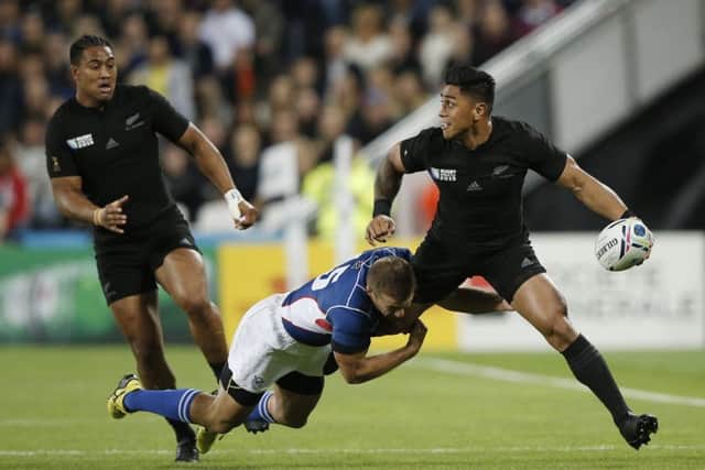 New Zealand centre Malakai Fekitoa looks to offload as he is tackled by Namibia fullback Johan Tromp. Picture: AFP/Getty