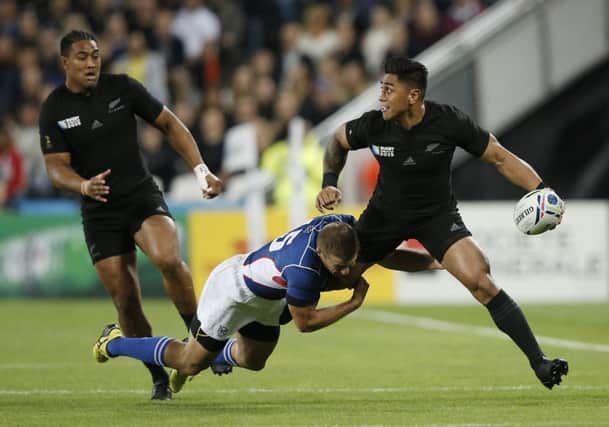 New Zealand centre Malakai Fekitoa looks to offload as he is tackled by Namibia fullback Johan Tromp. Picture: AFP/Getty