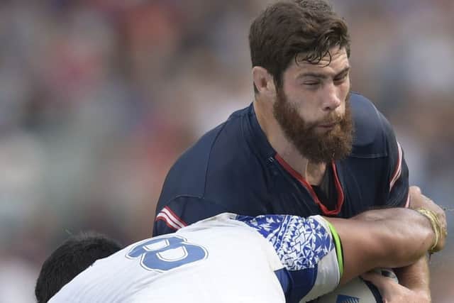 Greg Peterson takes on Samoa No 8 Ofisa Treviranus in their opening Pool B game. Picture: AFP/Getty