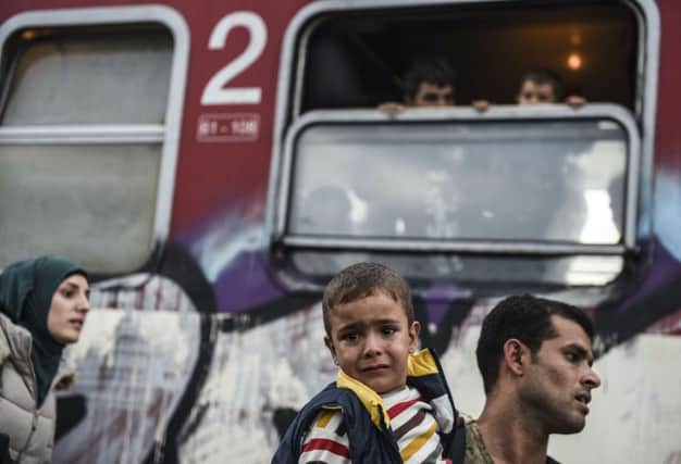 Migrants wait by to board a train transporting refugees to Serbia near the MacedonianGreek border. Picture: Getty