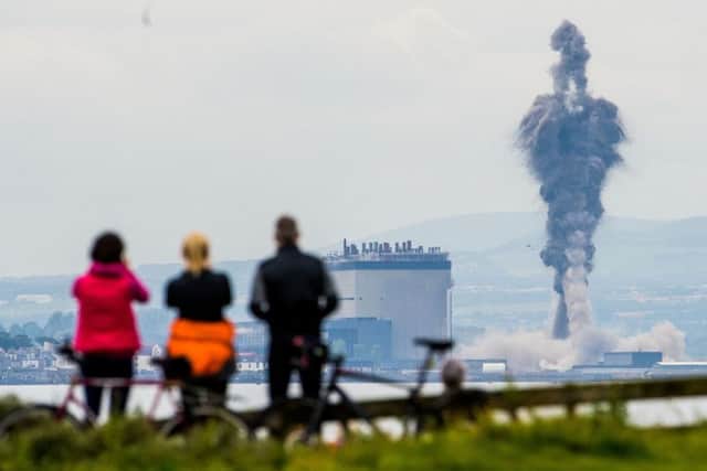 Locals watch as the towers are demolished. Picture: Ian Georgeson