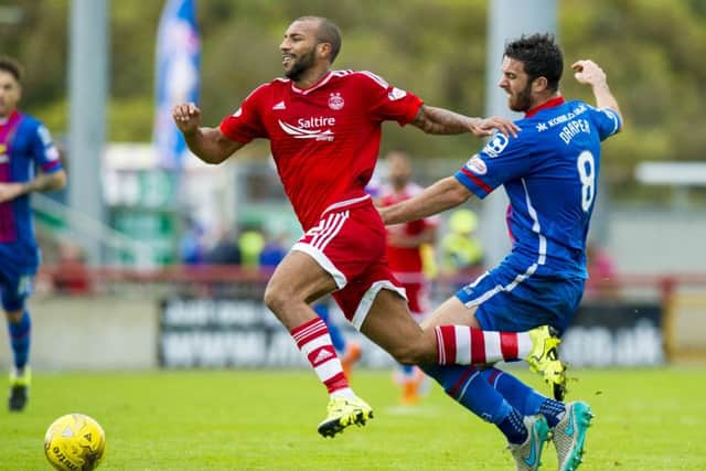 Aberdeen's Josh Parker (left) is tackled by Ross Draper. Picture: SNS