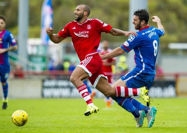 Aberdeen's Josh Parker (left) is tackled by Ross Draper. Picture: SNS