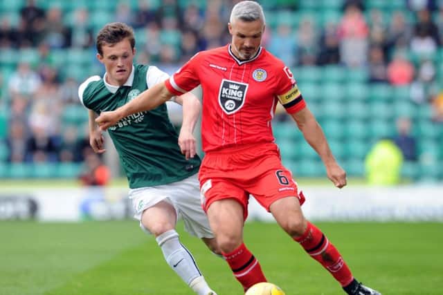 Jim Goodwin, holding off Liam Henderson, gave St Mirren the platform to claim a point at Easter Road. Picture: Lisa Ferguson