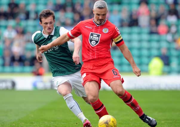 Jim Goodwin, holding off Liam Henderson, gave St Mirren the platform to claim a point at Easter Road. Picture: Lisa Ferguson