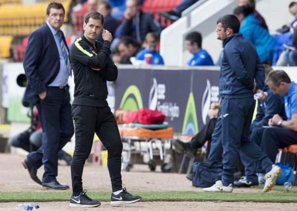 Jackie McNamara, right, cuts a dejected figure as Tommy Wright looks on. Picture: SNS