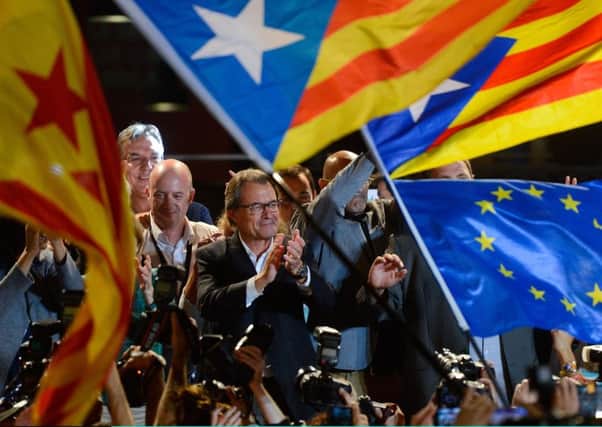 Artur Mas, president of Catalonia, centre, celebrates as the Catalanist coalition Junts Pel Si (Together for Yes) claim victory in the regional elections held on Sunday. Picture: Getty Images