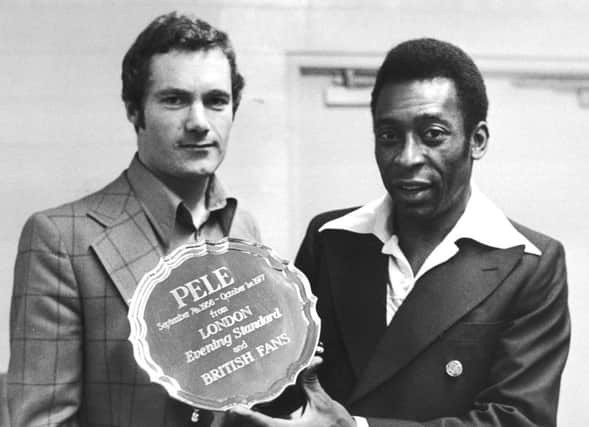 Evening Standard journalist Michael Hart presents Pele with an engraved silver salver to mark his retirement after his last match in New York, 1st October 1977. His final game was between the New York Cosmos and Santos, his old Brazilian club, Pele played for both sides during the match. (Photo by Evening Standard/Hulton Archive/Getty Images)