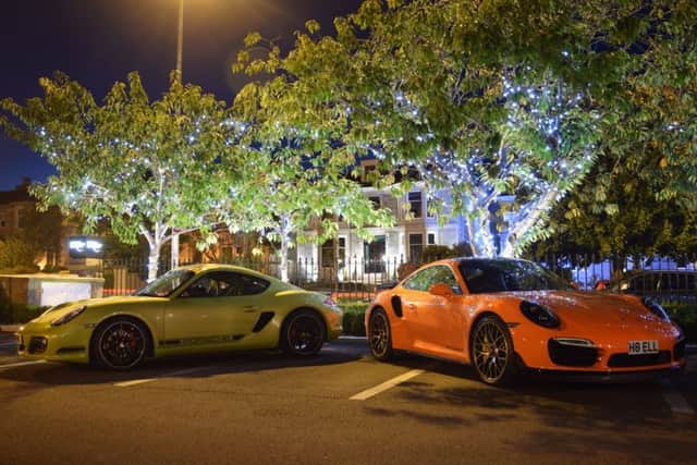 Two Porsches share the light of the Chester Hotel's car park.