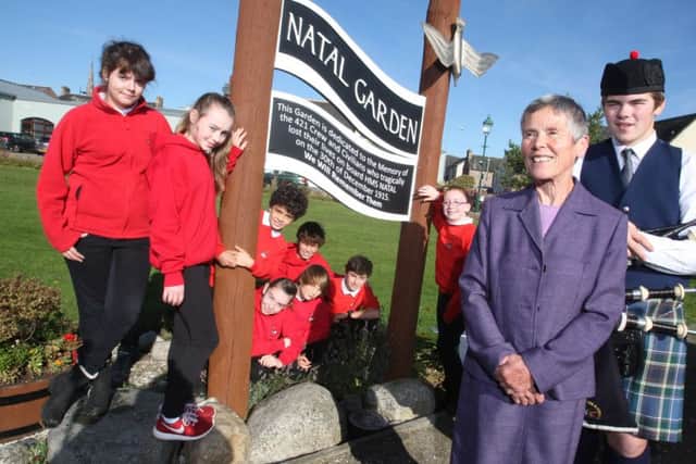 Rosalind Cahill, the granddaughter of Captain Back with children from Cromarty Primary School.