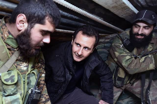 Syrian President Bashar Assad, centre, speaks to troops on the front line. Picture: AP