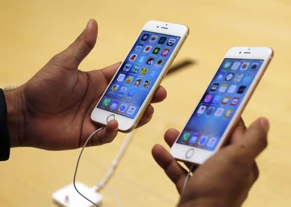 A customer tries out the new Apple iPhone 6s at an Apple store. Picture: AP