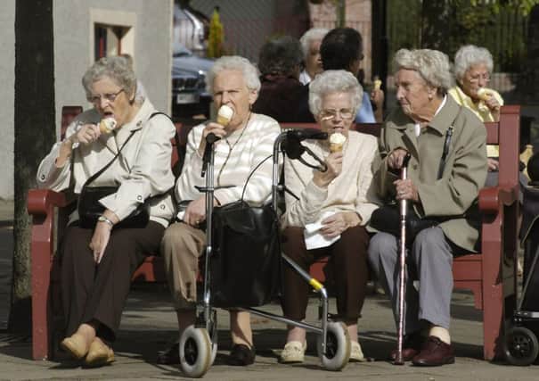 Four active pensioners sitting on a bench eating ice cream in Callander, Perthshire. OAP's. for special reports