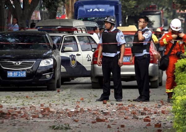Chinese police officers stand at the scene of the explosion in Liucheng yesterday. Picture: AP