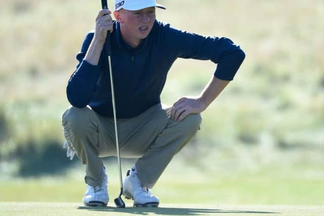 Englishman Jimmy Mullen lines up a putt en route to his 64 at Kingsbarns