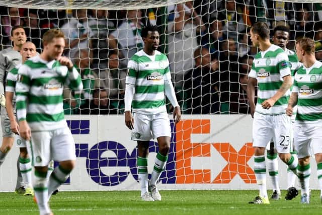 Efe Ambrose, centre, stands dejected after a second goal by Fenerbahce. Picture: SNS Group