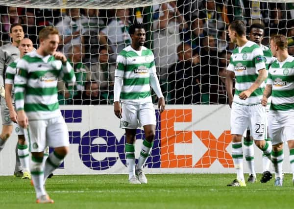 Efe Ambrose, centre, stands dejected after a second goal by Fenerbahce. Picture: SNS Group