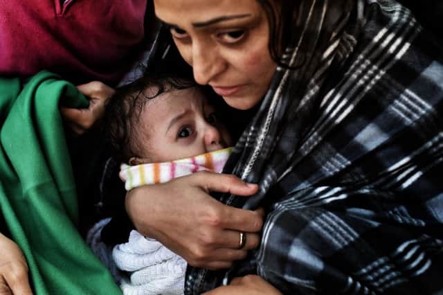 A refugee holds her baby after crossing the Aegean sea from Turkey. Picture: Getty Images