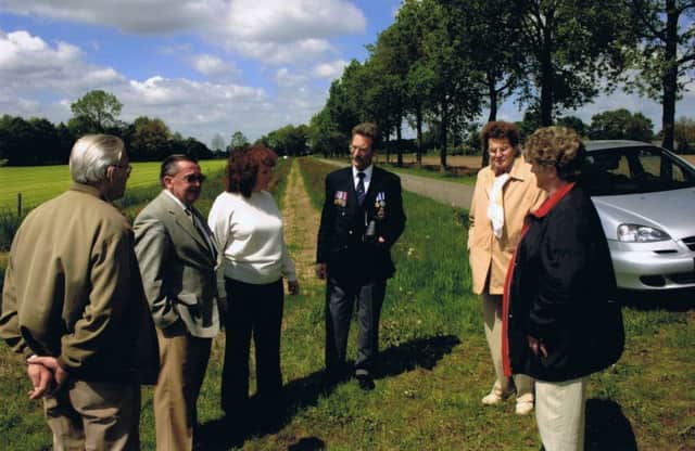 Colin Cripps (centre) with Dutch villagers near the crash site of the Lancaster carrying his uncle near Raalte in Holland on 13 June, 1943