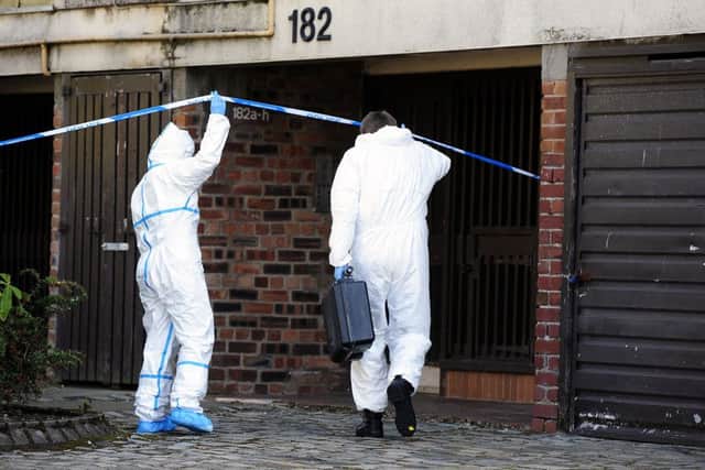Forensic experts inspect the scene of the murder in Cumbernauld's Glenhove Road. Picture: Michael Gillen