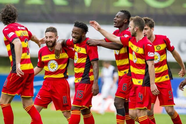Partick Thistle's Mustapha Dumbuya, centre, celebrates his goal. Picture: SNS