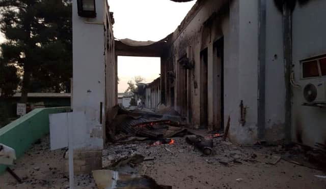 The bombed-out hospital, still ablaze after the attack. Picture: AP