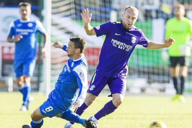 Hibernian midfielder Dylan McGeouch, right, challenges for the ball with Mark Millar at Palmerston Park on Saturday. Picture: SNS