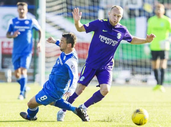 Hibernian midfielder Dylan McGeouch, right, challenges for the ball with Mark Millar at Palmerston Park on Saturday. Picture: SNS