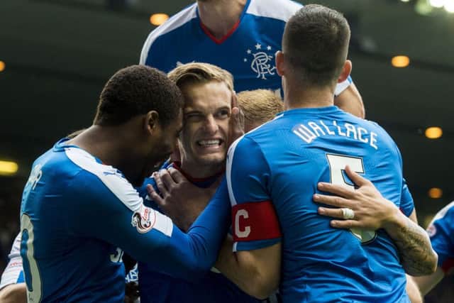 Dean Shiels, centre, is mobbed by his teammates after opening the scoring for Rangers. Picture: SNS