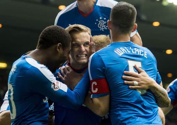 Dean Shiels, centre, is mobbed by his teammates after opening the scoring for Rangers. Picture: SNS
