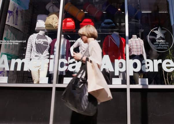 A pedestrian passes an American Apparel storefront in Chicago. Picture: Getty Images