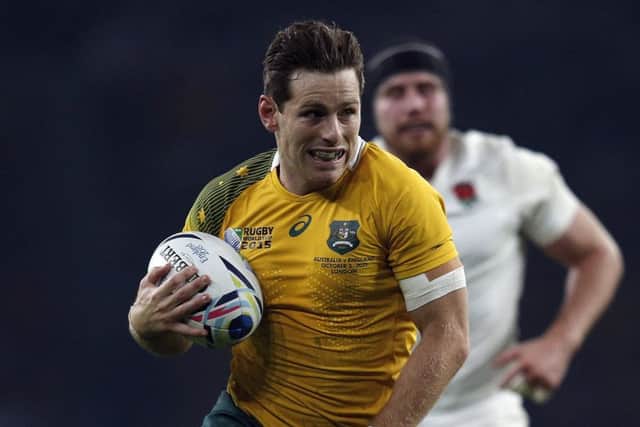 Australian stand-off Bernard Foley runs in for his second try against England. Picture: Getty