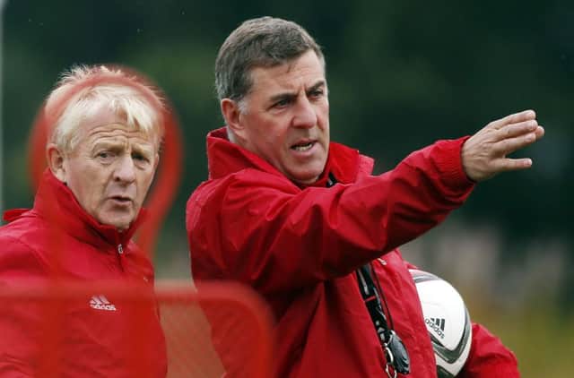 Scotland assistant manager Mark McGhee points the way for his boss Gordon Strachan during a training session yesterday . Picture: PA