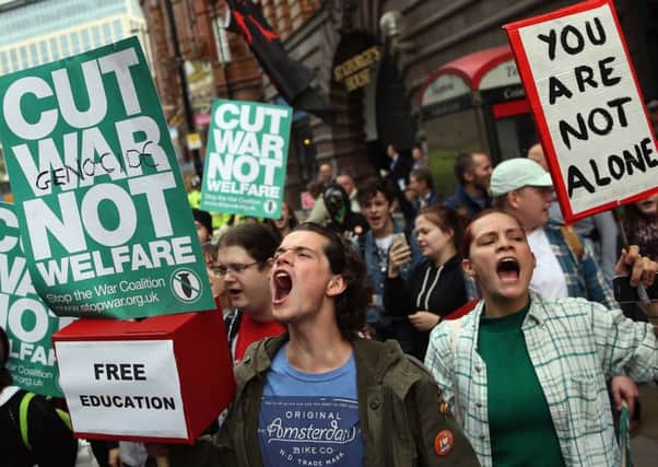 Anti-austerity protesters gather outside Manchester Central during on the second day of the Conservative party conference yesterday. Picture: Getty