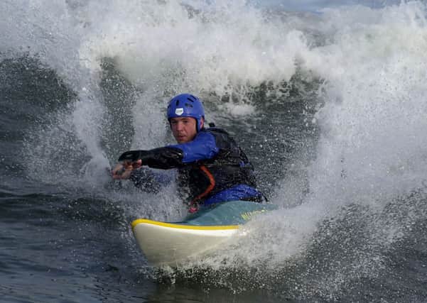 A competitor in the Scottish Paddle Surf Championship rides the waves in a kayak. Picture: Ian Rutherford