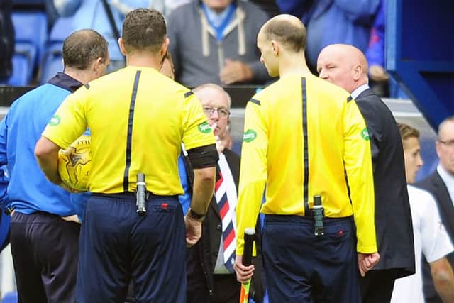 Referee John McKendrick talks to Falkirk boss Peter Houston. Picture: Michael Gillen