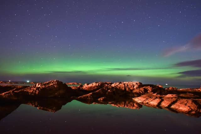 The Northern Lights are reflected in rock pools on the beach in Hopeman, Moray. Picture: Hemedia