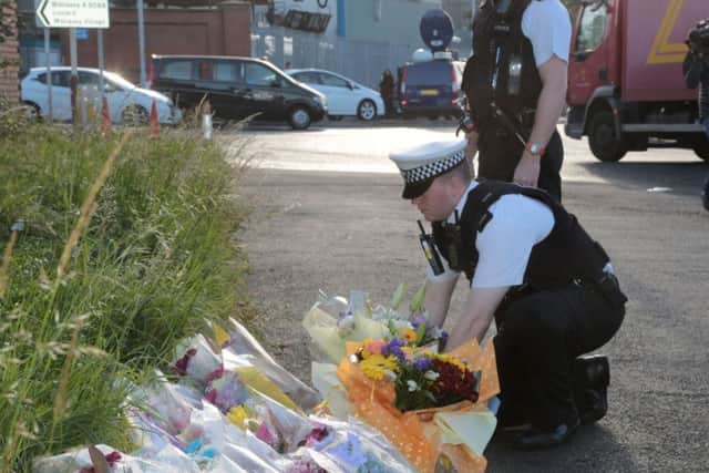Road traffic officers in Wallasey, Merseyside, leave flowers near to where Pc David Phillips was mown down. Picture: PA
