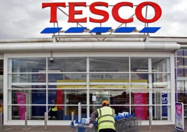 Tesco's profits tumbled but the grocer said its sales trends were improving