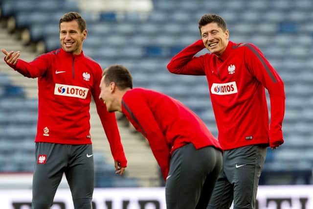 Polands captain and talismanic striker Robert Lewandowski, right, shares a joke with midfielder Grzegorz Krychowiak. Picture: SNS