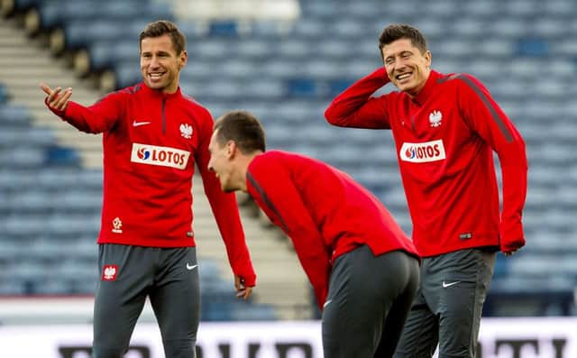 Polands captain and talismanic striker Robert Lewandowski, right, shares a joke with midfielder Grzegorz Krychowiak. Picture: SNS