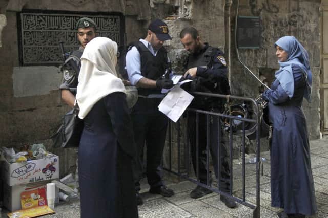 Israeli police check the papers of Palestinian women in Jerusalems Old City as tensions mount. Picture: AP