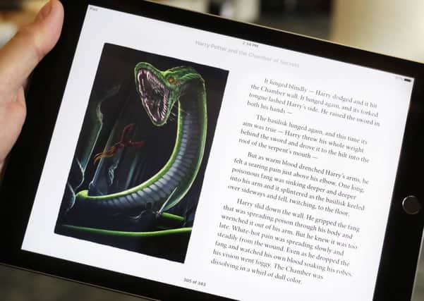 The J.K. Rowling books are being released with animated or interactive illustrations, but only through Apples iBooks Store and require the use of an Apple mobile device or a Mac computer. (AP Photo/Mark Lennihan)