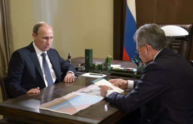 Russian President Vladimir Putin with his defense minister Sergei Shoigu. Picture: AP