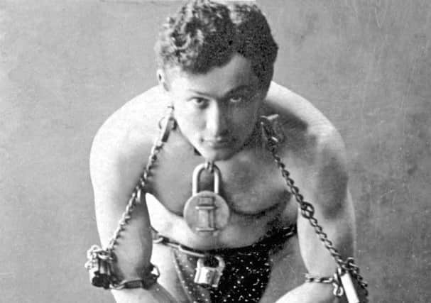 Harry Houdini in trademark padlock and chains