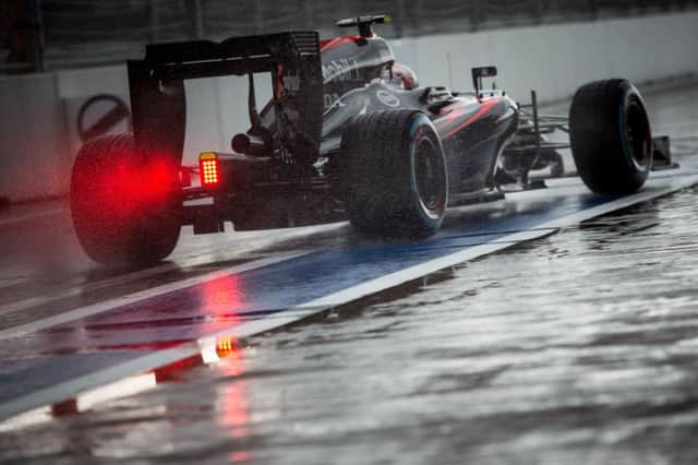 Britains Jenson Button negotiates the wet track conditions at Sochi in his McLaren Honda. Picture: Getty