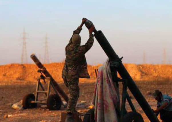 Islamic State militants prepare to fire mortars at Syrian government positions in  the north-east  province of Aleppo. Picture: AP