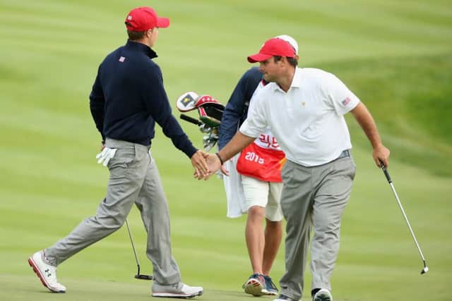 Jordan Spieth of the US celebrates with partner Patrick Reed after a birdie putt on the ninth during the Saturday afternoon four-ball win over International pair Jason Day and Charl Schwartzel  at the Presidents Cup.  Picture: Scott Halleran/Getty Images
